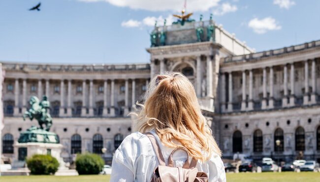 Traveller looks out at Schoenbrunn Palace in Vienna