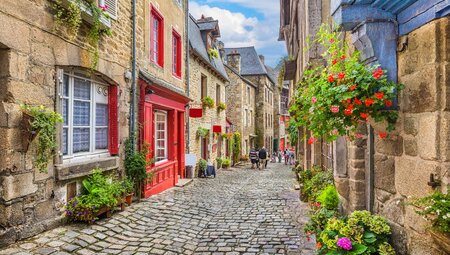 Cobble stone streets and houses with plants, Normandy, France
