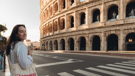 Traveller visits the Colosseum at dawn, Rome, Italy