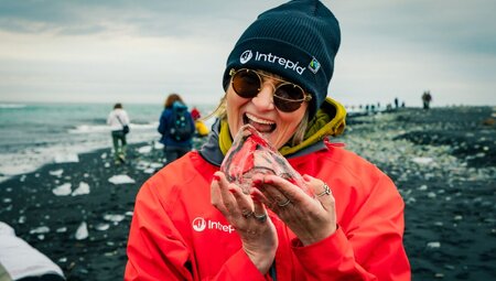 Leader Jura holding fresh ice in Jokulsarlon Glacier Lagoon