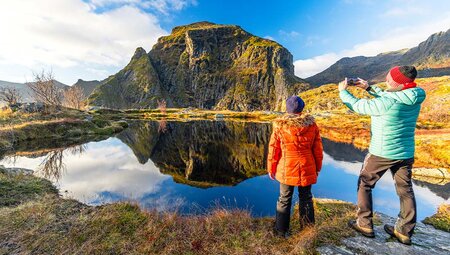 Travellers photographic Fjord on hike in Lofoten, Norway