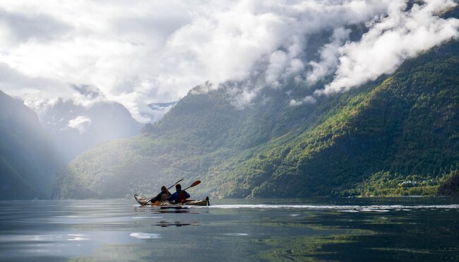 Intrepid travellers kayaking as a pair on Nærøyfjord on a tour of Norway