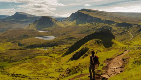Intrepid traveller looking out at the landscape while walking Quiraing loop on the Isle of Skye