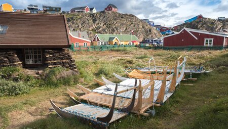 Varietal toboggans rest in springtime in the village of Sisimiut western Greenland