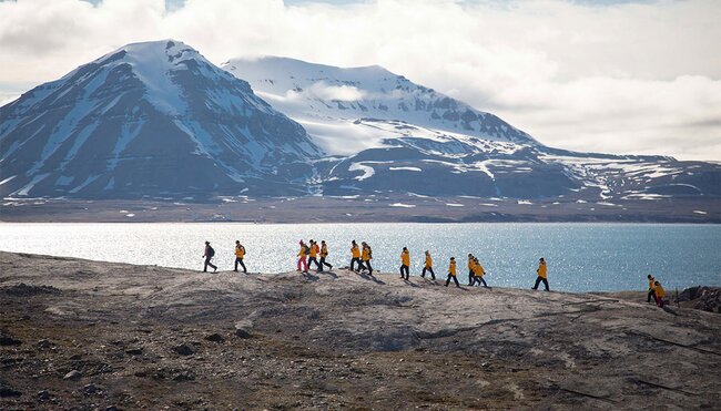 Group of travellers hiking in Svalbard