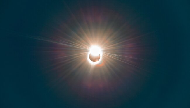 A total solar eclipse in progress as the sun begins to dissappear behind the moon