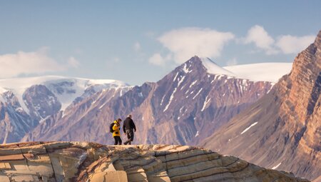 Travellers exploring the dolomites around Kong Oscar Fjord in eastern Greenland