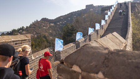Leader takes travellers on a walk on the Great Wall Of China, Beijing, China