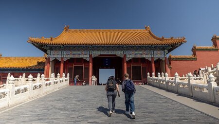 Two travellers walking towards the Gate of Supreme Harmony in the Forbidden City, Beijing, China