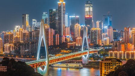 Choingqinng the Cyberpunk cityscape with bright light buildings and a sweeping bridge