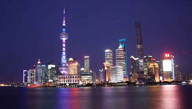 The Shanghai skyline at night across the water