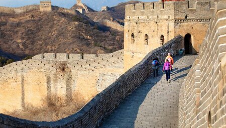 Great Wall of China with travellers walking in the background