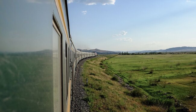 Green Trans-Mongolian train curves into the grasslands of Mongolia and China