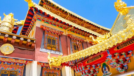 Gold rooves and colourful eaves of Sumtsenling Monastery in Shangri-La, China