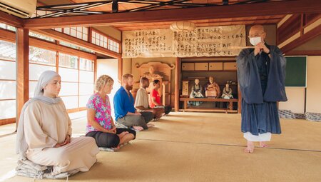 Group of Intrepid travellers is instructed in Zen Buddhist meditation by monk at Daitokuji Temple