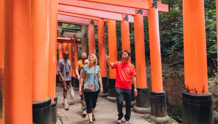 Intrepid leader shares information as travellers walk through the Fushimi Inari gates