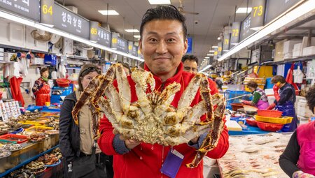 Leader holding huge crab in Jagalchi seafood market in Busan South Korea