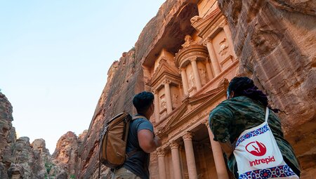 Intrepid travellers look up at the carved facade of Petra in Jordan