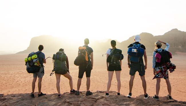 Group of hikers overlooking the desert in Wadi Rum, Jordan