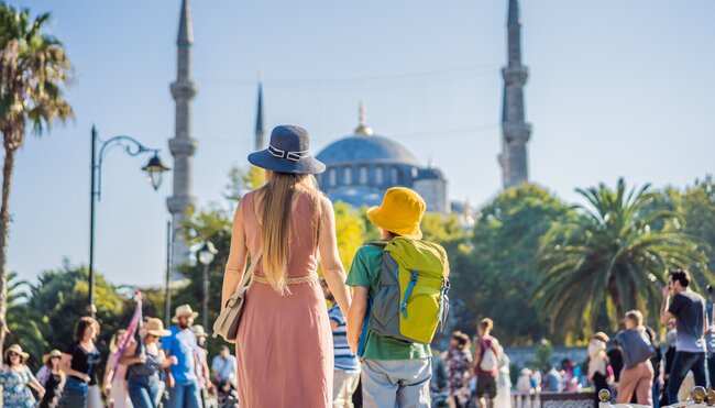 Intrepid traveller parent and child taking in the Blue Mosque in Istanbul, Turkiye