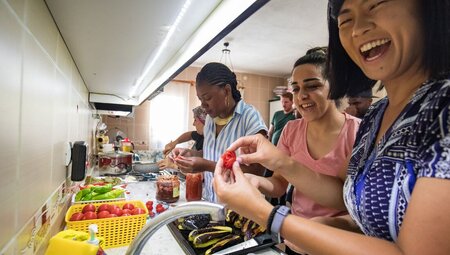 Intrepid travellers take a cooking class in Cappadocia laughing and smiling as they do