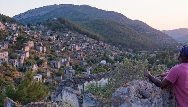 Group of travellers watching sunset in Kayakoy village, Turkey