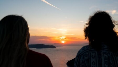 Intrepid travellers watching the sunset in Santorini