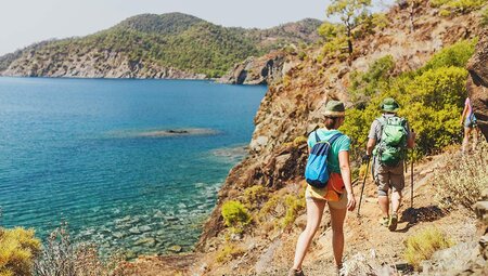 Travellers hiking along the Lycian Way with blue waters in the background, Turkey