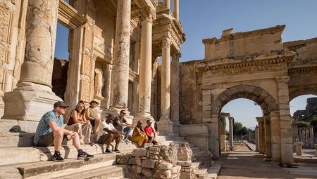 Intrepid tour group enjoy the afternoon sun in the ancient library in Ephesus Turkey