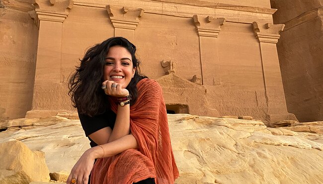 Smiling local leader seated near the Nabatean tombs, Hegra, Al Ula, Saudi Arabia