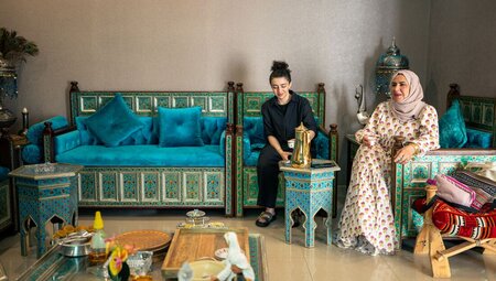 Locals sitting and smiling at a home visit in Riyadh, Saudi Arabia