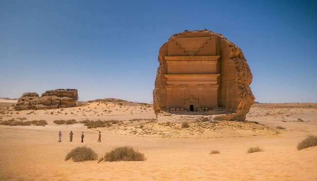 Travellers approach Qaṣr al-Farīd, the largest monument in Hegra, a collection of over 100 carved tombs and facades dating back to the 1st Century CE