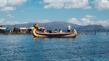 Intrepid travellers cross a reed boat to the Floating Island of Lake Titicaca