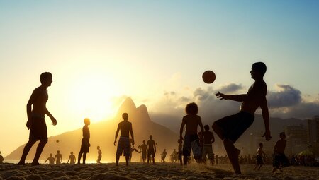 Playing football on Copacabana beach in Rio de Janeiro
