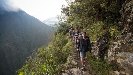 travellers hike machu picchu, Peru