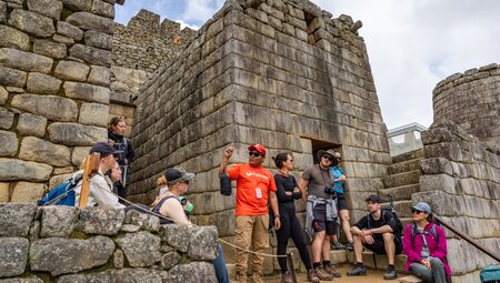 Surrounded by Machu Picchu stone walls Intrepid leader talks about the history of the place on the Inca Trail