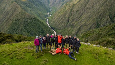 Intrepid travellers and leaders pose for a group shot at Intipata Archaeological Site on the Inca Trail in peru