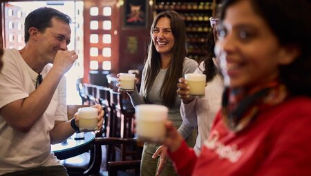 Intrepid travellers and leader enjoy fresh pisco sours in Cusco Peru