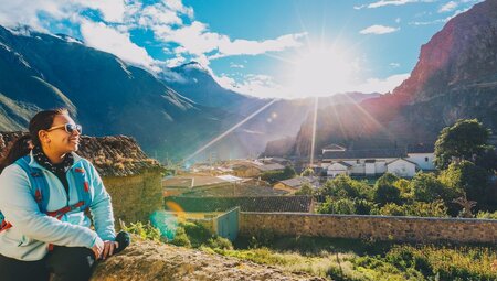 Intrepid traveller stops to rest and look out over the town of Ollantaytambo in Peru