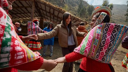 Huilloc community dances with Intrepid travellers in Sacred Valley Peru