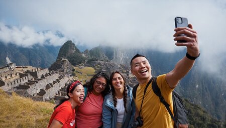 Intrepid travellers pose for a well deserved selfie at Machu Picchu