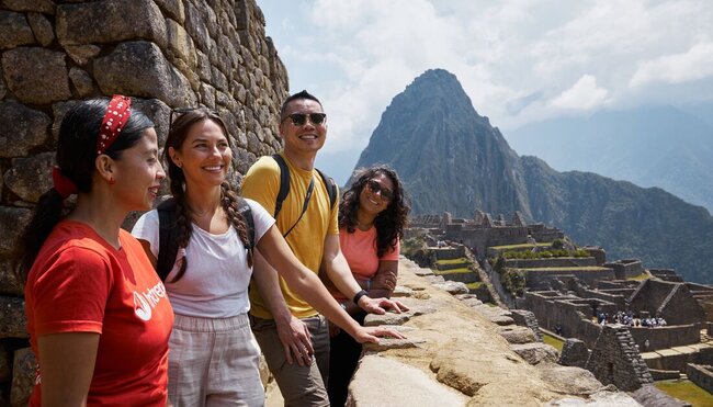 Intrepid travellers finally relax after a long trek at Machu Picchu in Peru