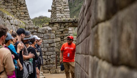 Intrepid leader talking about Machu Picchu with travellers in Peru