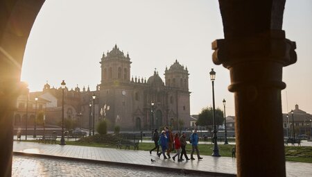 Intrepid travellers get familiar with Cusco walking through the Plaza de Armas in the early morning