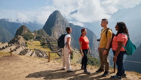 Intrepid leader talks to travellers as they stop in awe at Machu Picchu in Peru