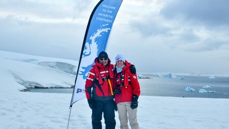 Travellers embrace happily at the landing of Portal Point in northern Antarctica