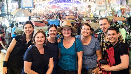 Group of travellers exploring the colourful markets in Madurai, India