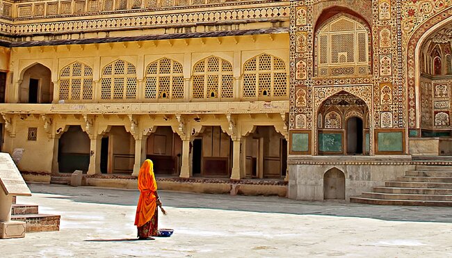 HHPHC - Persona walking through decorative gate of Amber Fort in Jaipur, India