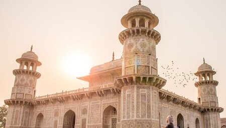 Traveller sits by Agra and watches sunrise