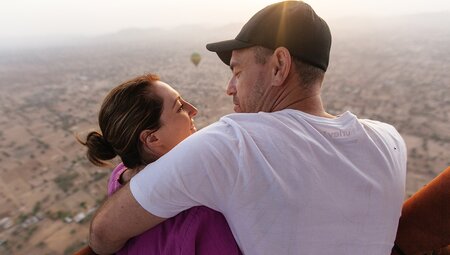 Couple hugging in a balloon ride over Jaipur in India on an Intrepid Travel tour.